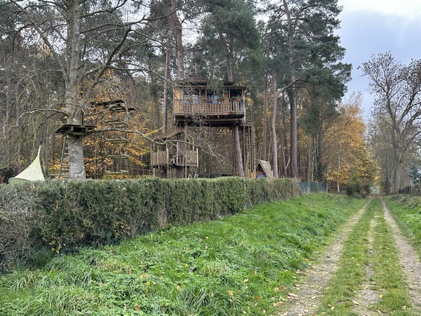 Nous traversons la D25, et continuons sur ce chemin. A gauche, une impressionnante cabane, et un parcours d'accrobranche dans un jardin.
