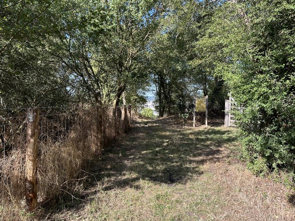 La rue de la Censurière se prolonge en chemin qui arrive ici au rucher pédagogique de la ville d'Evreux, destiné à sensibiliser le public sur l'importance des insectes pollinisateurs.