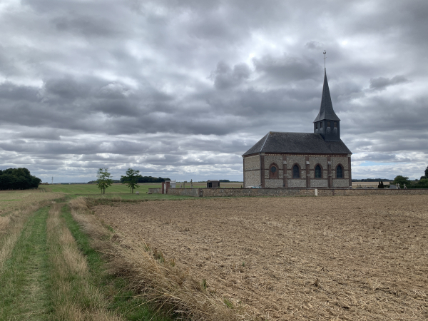L'église Saint-Aubin du Mesnil-Fuguet a été bâtie en 1861, à l'initiative de l’abbé de Bouchon, curé de Sacquenville, à l'écart du bourg mais à l'emplacement de l'ancienne église qui avait été démolie peu après la Révolution.