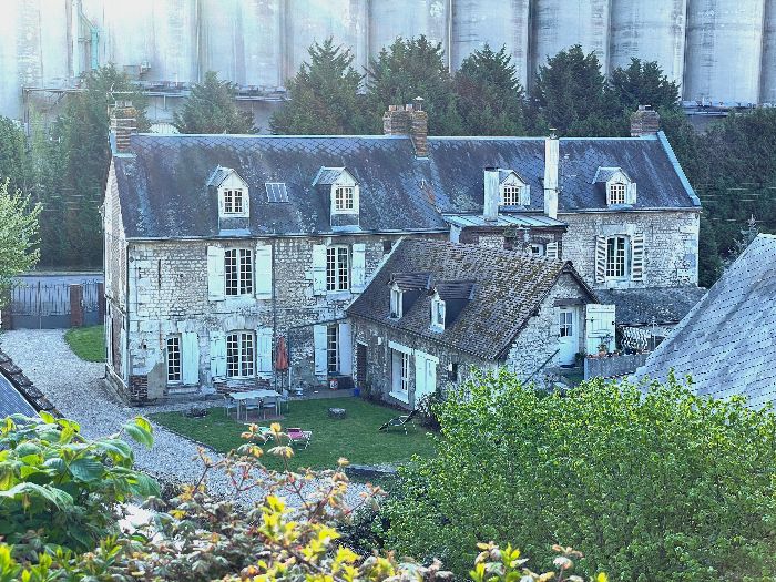 Je monte la sente de Quenneport. Derrière moi, cette grande maison de pierre à double corps est le manoir de Quenneport (XVIIe), désormais dominé par les silos de Sénalia.