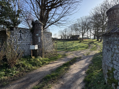 Rue du Prieuré d'Ecretteville-sur-Mer. Le nom de prieuré était souvent, dans le langage courant, attribué à un petit manoir du représentant d'abbé, chargé de gérer des propriétés agricoles de l'une des grandes abbayes de Fécamp. A remarquer, la croix à gauche de l'entrée.